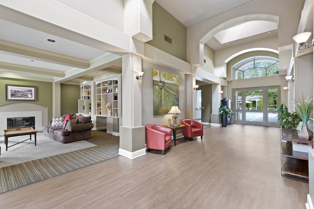 a large living room with furniture and a fireplace