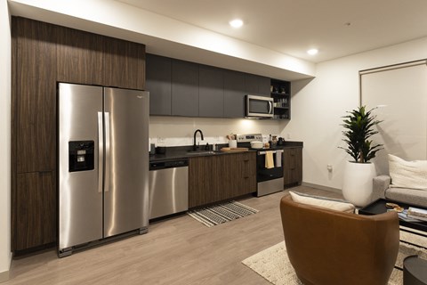 a kitchen with stainless steel appliances and a refrigerator