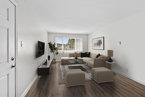 A living room with a brown couch and a white door.