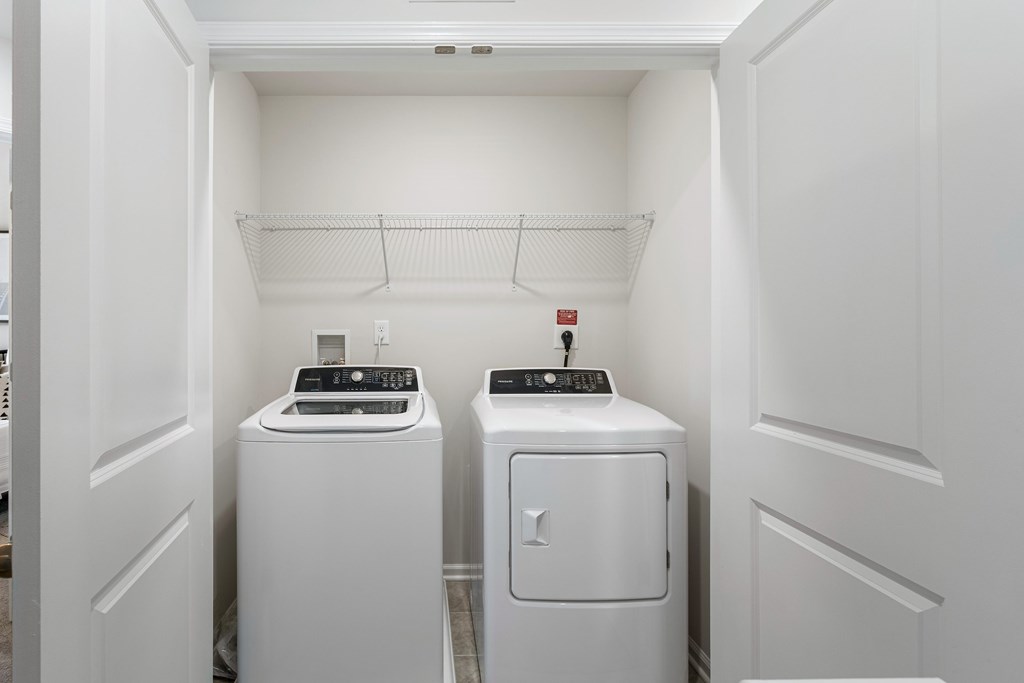 A small laundry room with a washer and dryer.