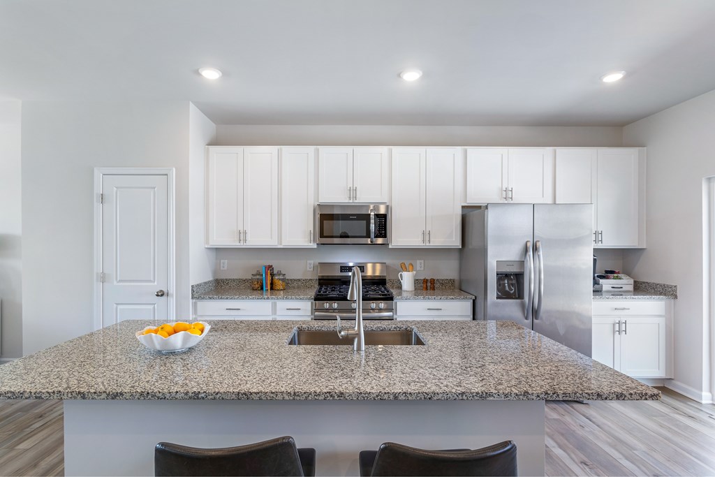 A kitchen with granite countertops and stainless steel appliances.