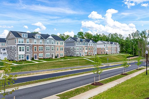 A row of houses with a street in front.