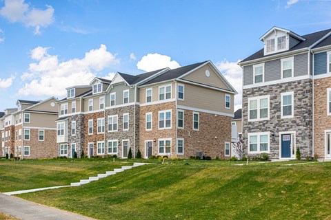 A row of modern brick apartment buildings.