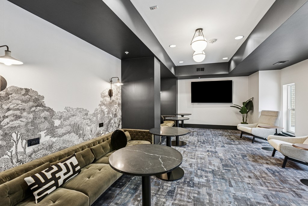 A modern living room with a large sofa and a television.