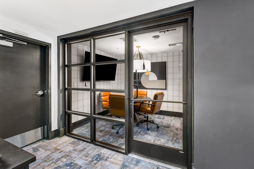 A room with a tiled wall and a glass door.