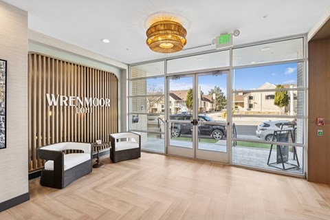 A reception area with a glass door and a sign that says Wrenmoor.