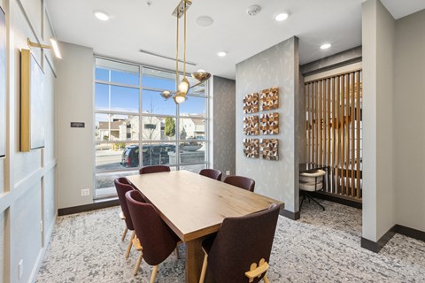 A conference room with a long table and chairs.