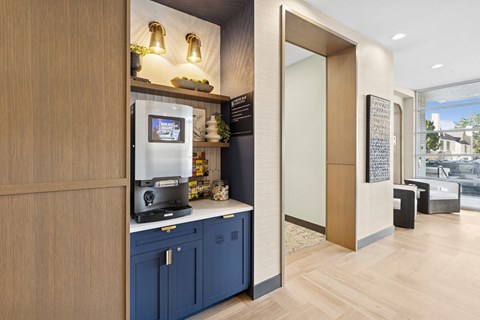 A modern kitchen with a wooden counter and blue cabinets.