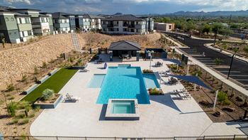 A large swimming pool with a slide in the middle of a residential area.