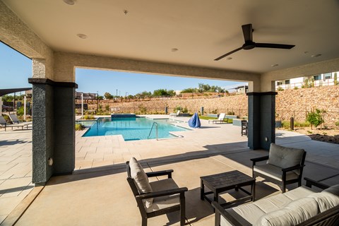 A patio with a pool and furniture.