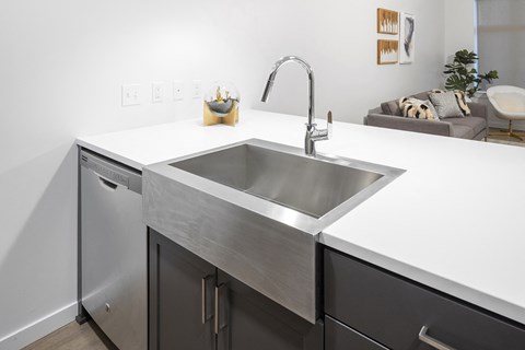 a kitchen with a stainless steel sink and counter top