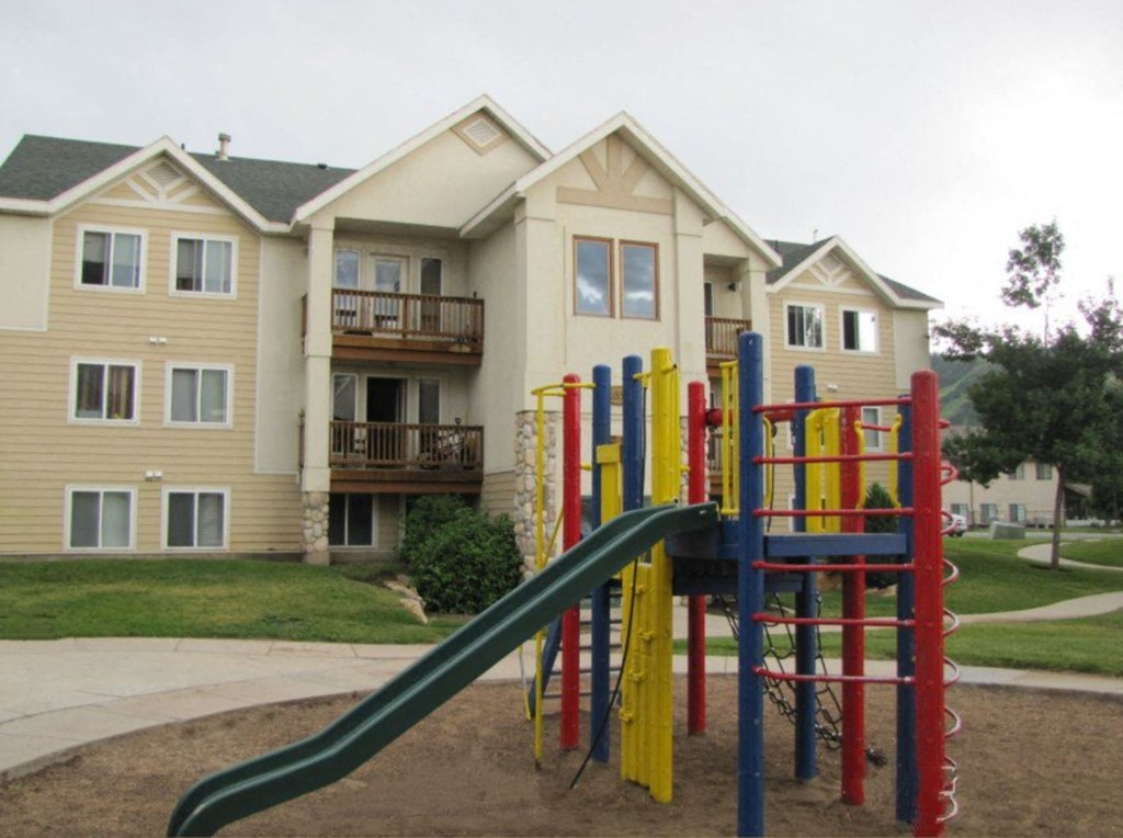the playground is in front of an apartment building