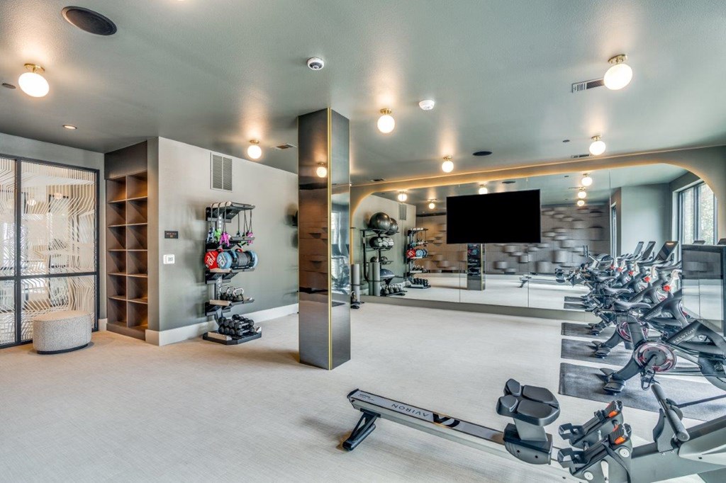 A spacious gym with a variety of exercise equipment.