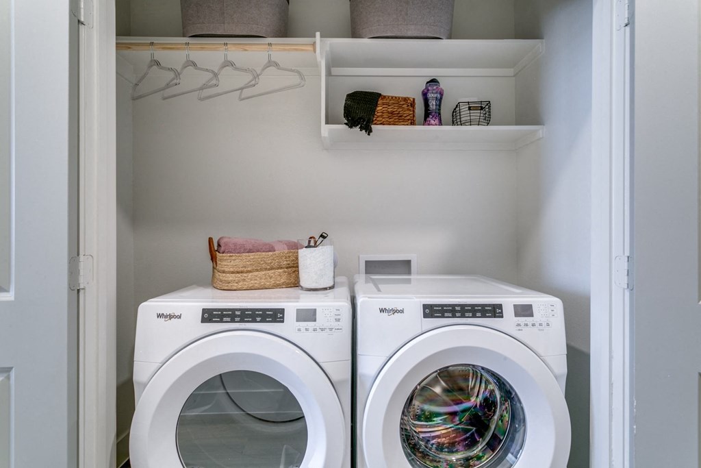 a laundry room with two washes and a dryer