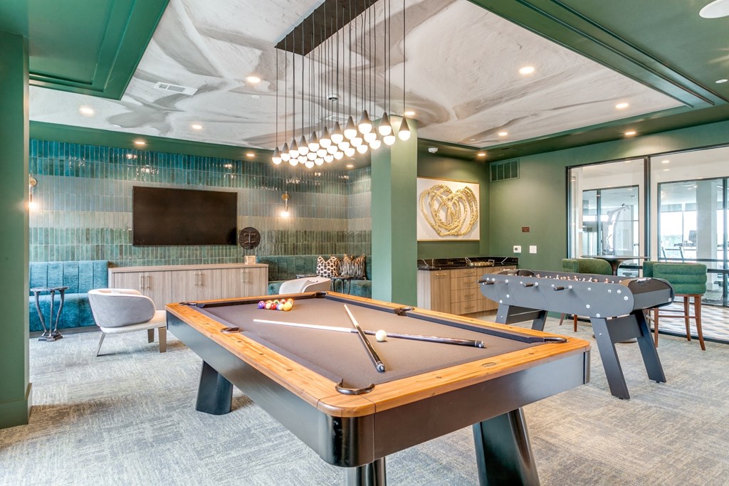 a game room with a pool table and a tv