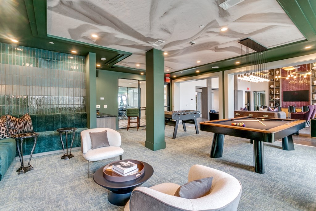 a billiards room with a pool table and a bar