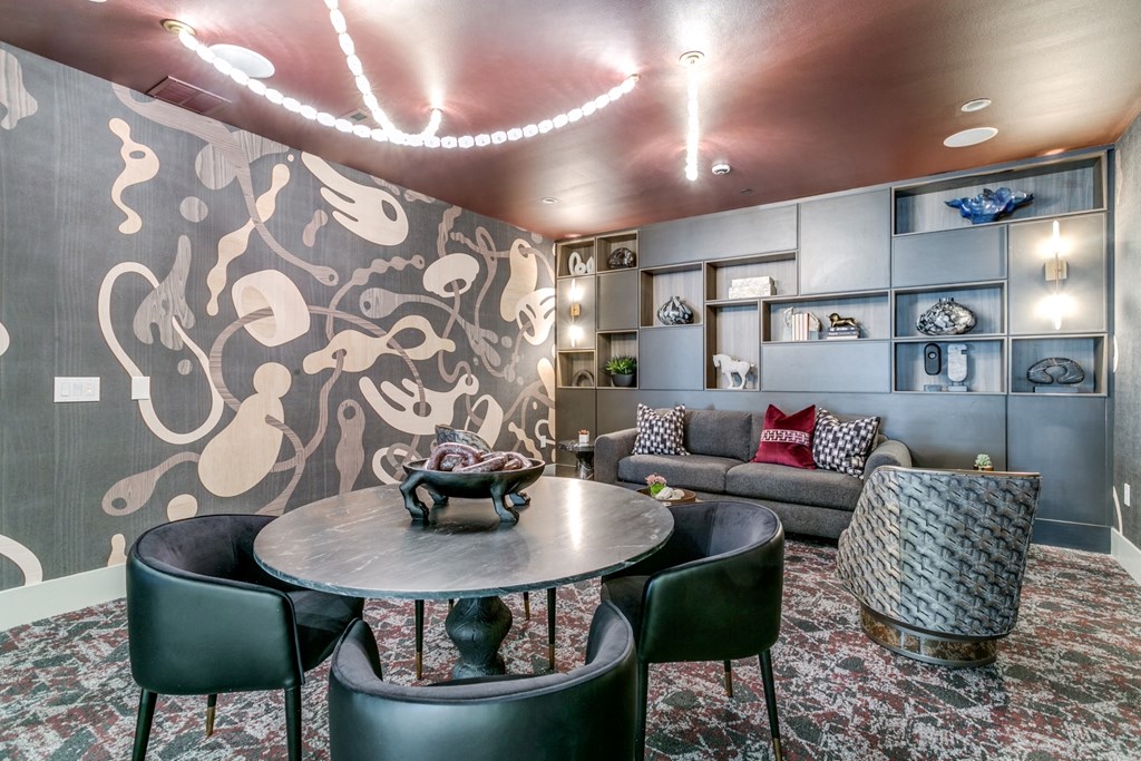 a living room with a couch and a table and chairs