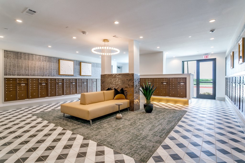 a lobby with couches and lockers in a building