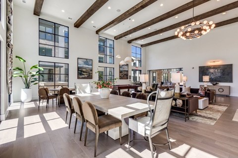A modern dining room with a large table and chairs.