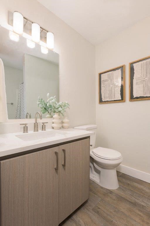 a bathroom with a toilet and a sink and a mirror
