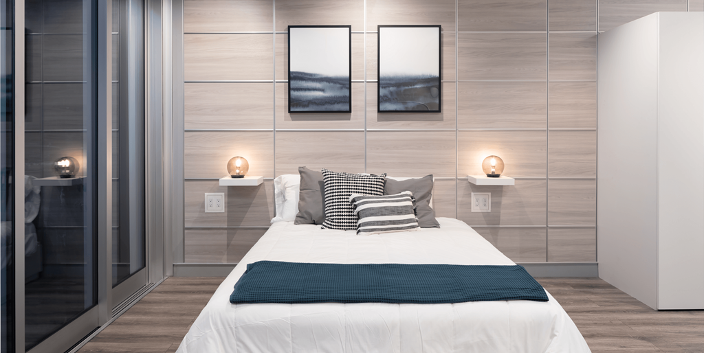 a bedroom with a bed and a glass door