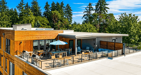 A modern house with a wooden exterior and a spacious deck.