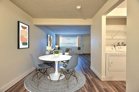 a dining room with a table and chairs and a kitchen