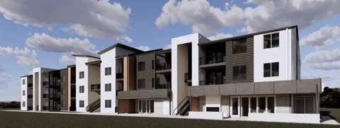 A modern apartment building with multiple balconies and staircases.