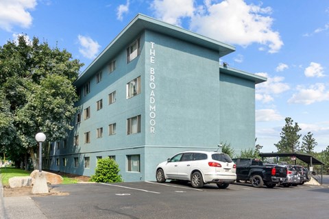 The Broadmoor building has a parking lot in front of it.