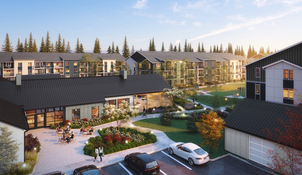 A modern residential area with houses and a parking lot.