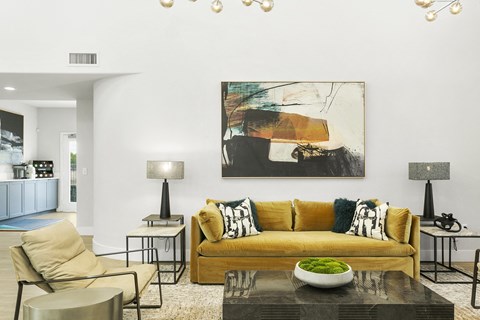 a living room with a yellow couch and a coffee table