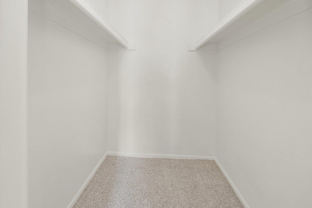 A room with a carpeted floor and white walls.