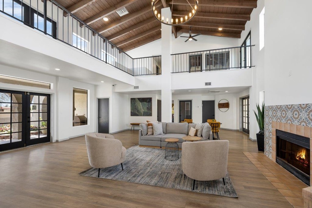 A modern living room with a fireplace and a large rug.