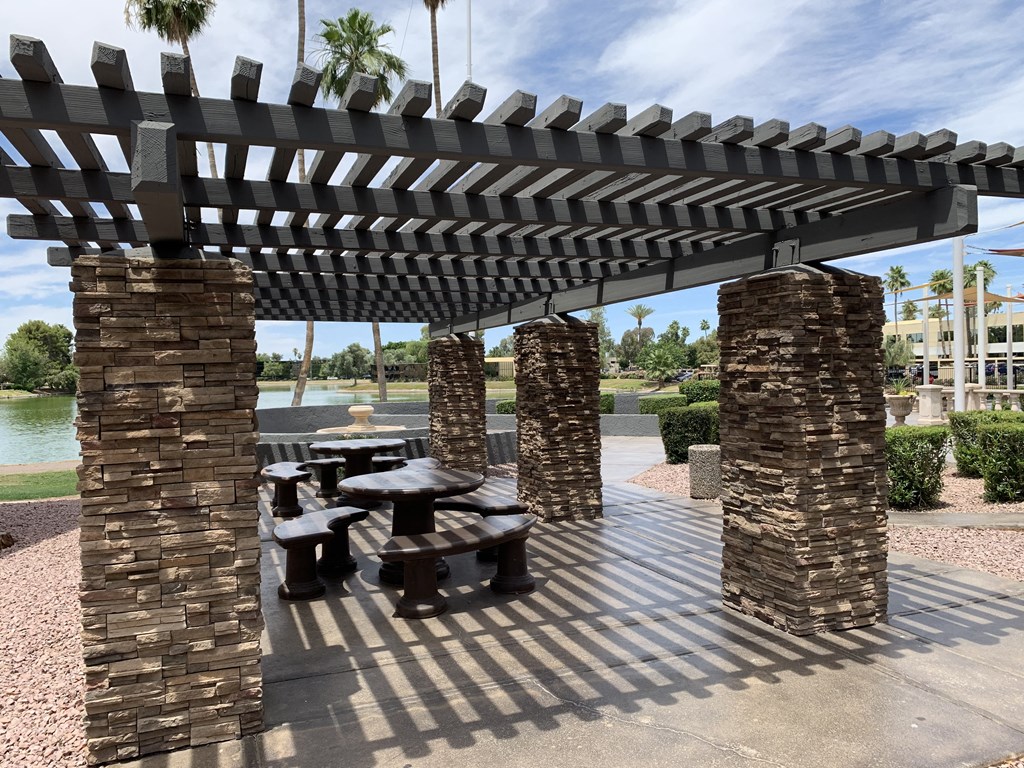 a picnic area with benches and a pergola