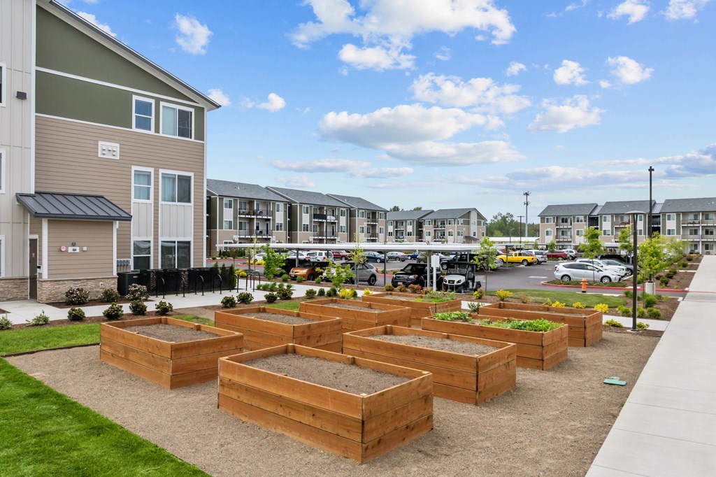 A row of townhouses with a parking lot in the background.