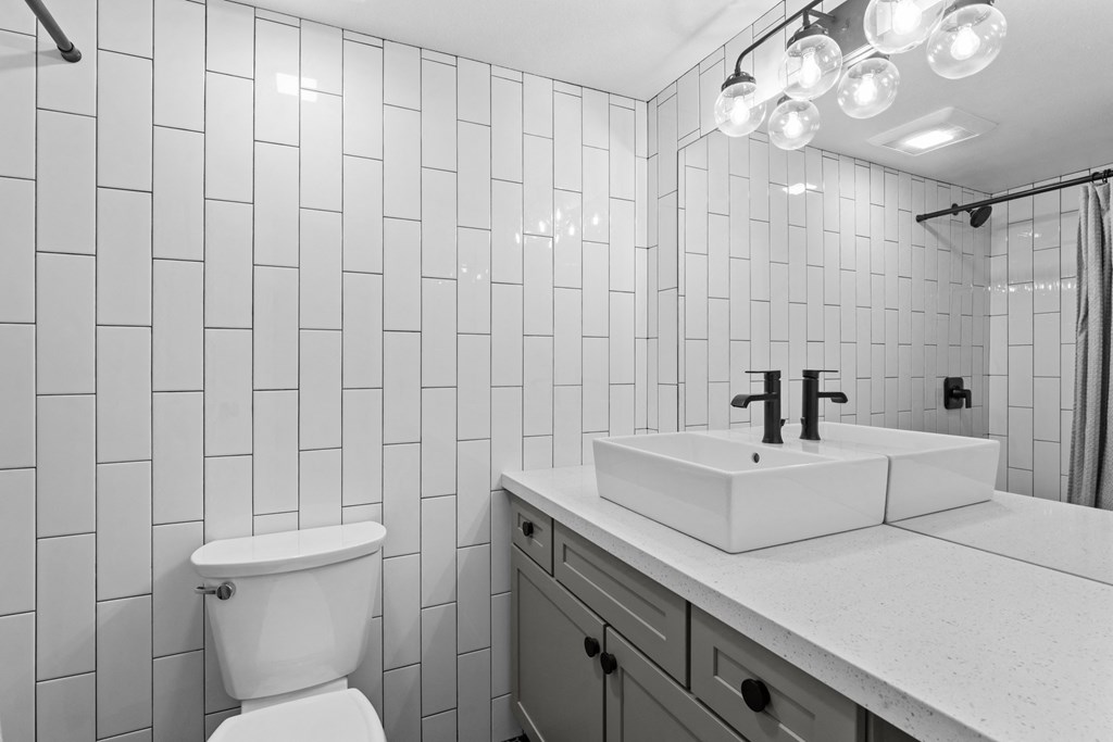 a bathroom with a toilet sink and a mirror