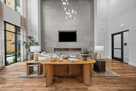A modern living room with a wooden coffee table and a flat screen TV mounted on the wall.