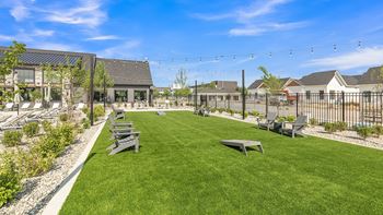 A sunny day at a park with benches and a playground.