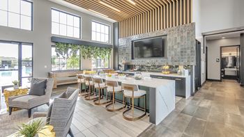 A modern kitchen with a bar area and a dining table.