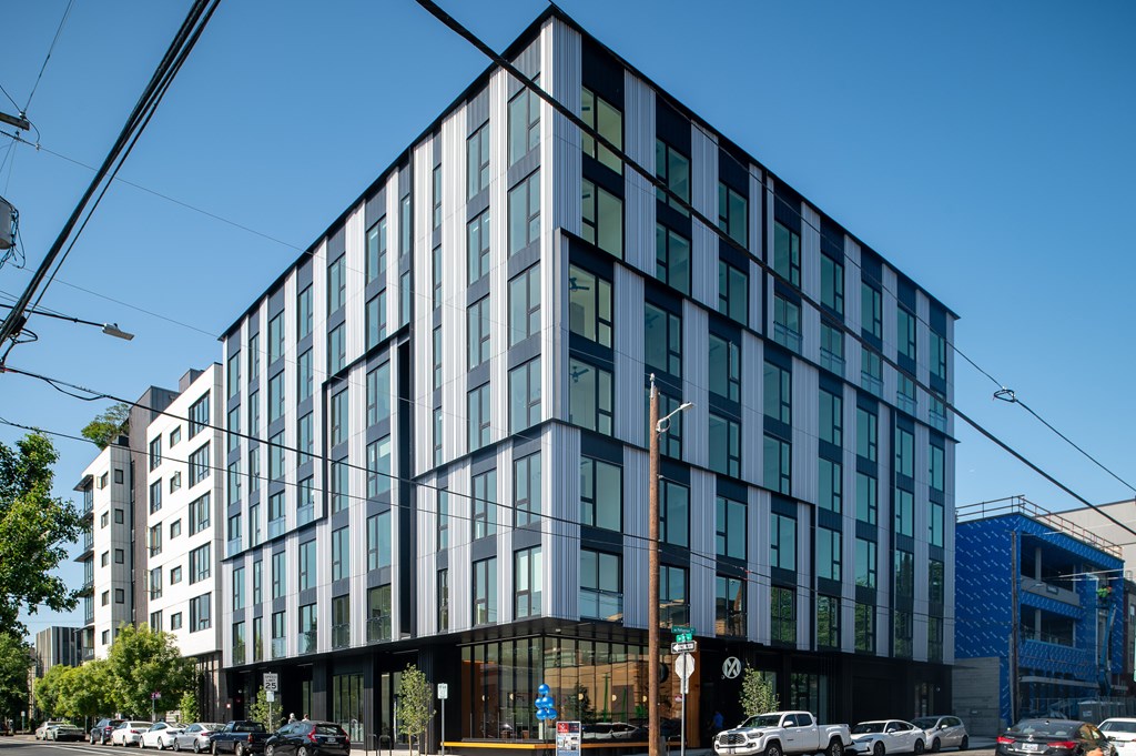 A modern building with a glass facade is shown.