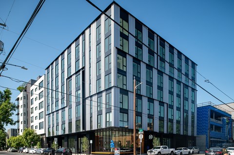 A modern building with a glass facade is shown.
