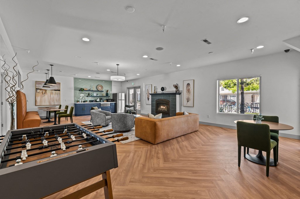 a living room with a fireplace and a foosball table