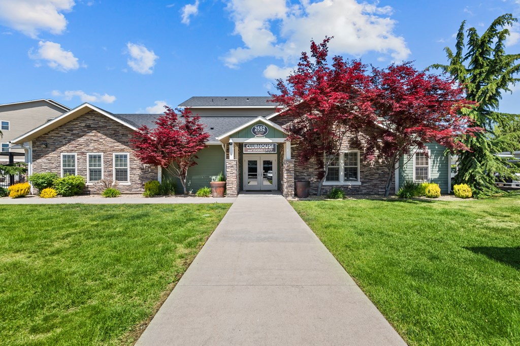 the front of a house with a sidewalk in front of it