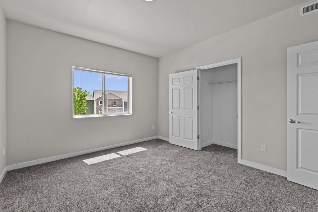 an empty room with a window and a door