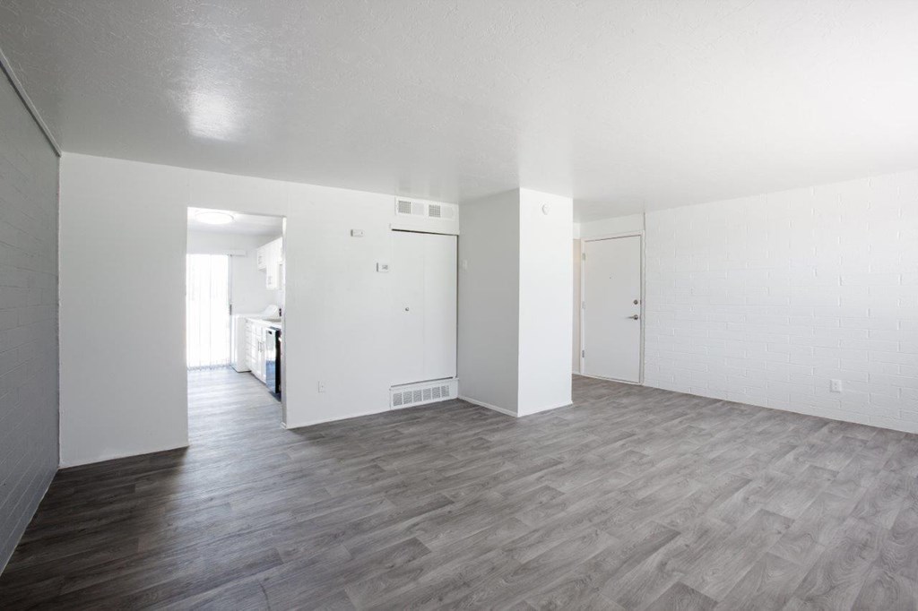 A room with a wooden floor and white walls.