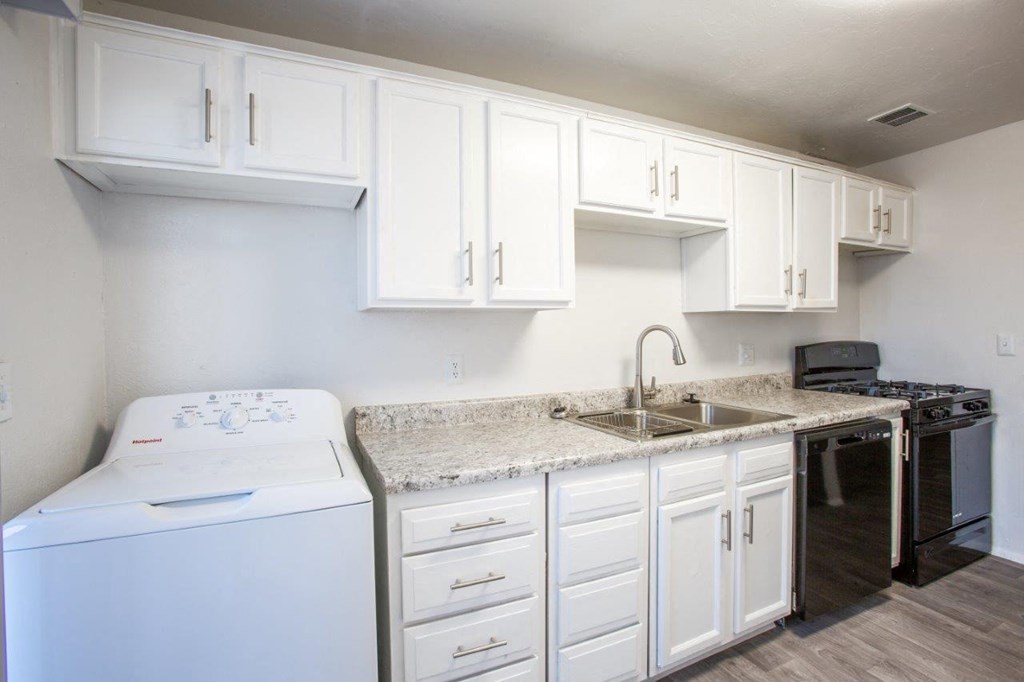 A white laundry room with a washer and dryer.