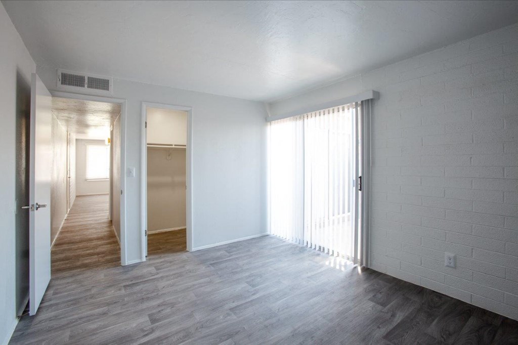 A room with white walls and a wooden floor.