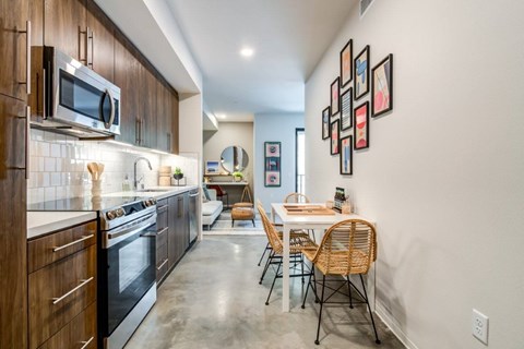 A modern kitchen with a dining table and chairs.