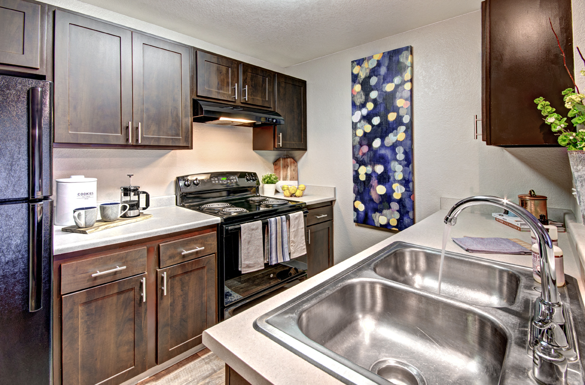 Apartments for Rent in Silverdale-Ridgetop Apartments Kitchen with Double Stainless Steel Sink and Matching Black Appliances