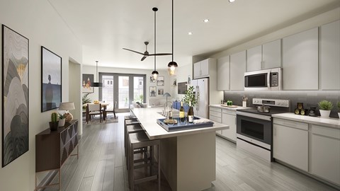 A modern kitchen with a large island and a dining area.